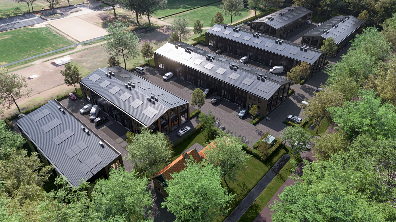 Luchtfoto van moderne bedrijfsunits met zonnepanelen en omringende bomen in Businesspark Soest, nabij Baarn