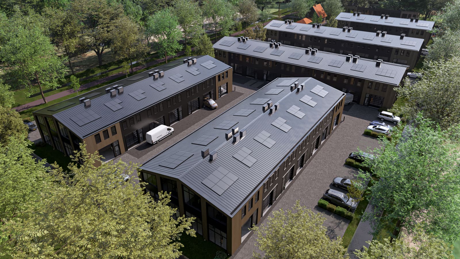 Luchtfoto van rij bedrijfsunits met zonnepanelen en parkeerplaatsen, omringd door groen in Businesspark Soest, gezien vanuit de lucht richting Baarn