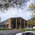 Straatbeeld van modern bedrijfsgebouw met houten gevel, huisnummer 59, parkeerplaatsen en bomen op Businesspark Soest, vlakbij Baarn