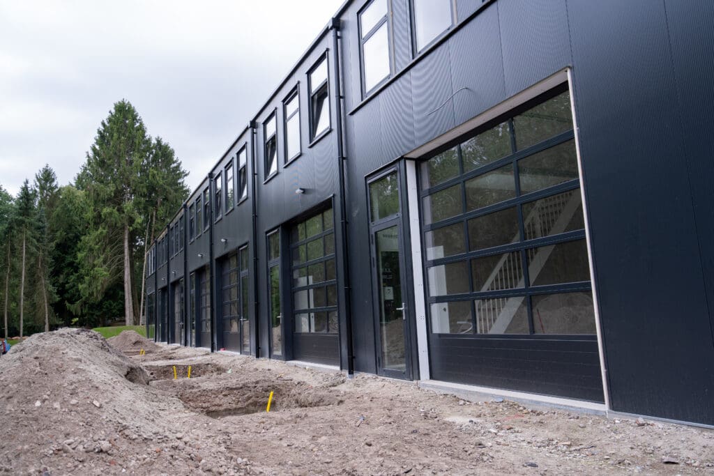 Bedrijfsunit met glazen overheaddeur en hoge pui in Soest